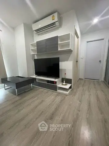 Modern living room with sleek furniture and air conditioning