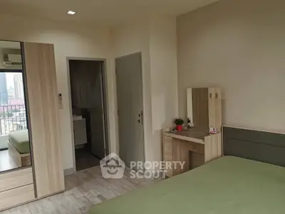 Modern bedroom with city view, featuring sleek furniture and a cozy atmosphere.