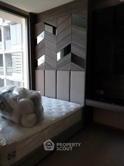 Modern bedroom with stylish headboard and natural light