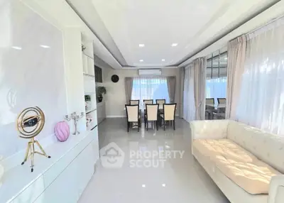 Elegant living room with modern decor and spacious dining area