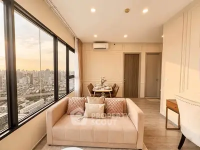 Luxurious high-rise living room with panoramic city views and elegant decor.