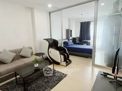 Modern studio apartment with massage chair and cozy living area