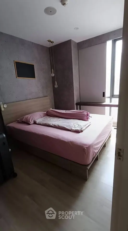 Cozy bedroom with modern decor and large window for natural light