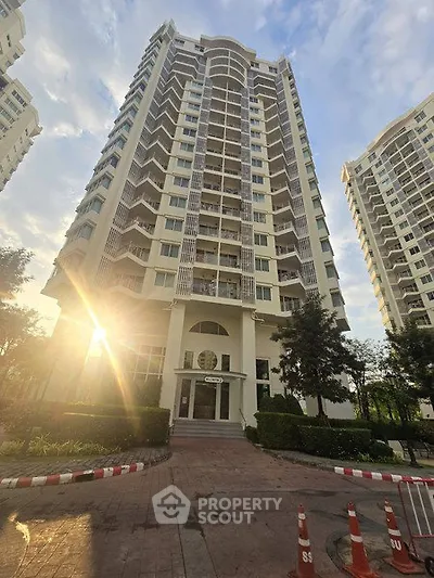 Stunning high-rise residential building with modern architecture and lush landscaping.