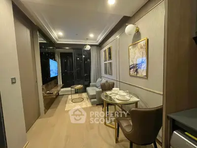 Modern living room with elegant decor and dining area, featuring a cozy sofa and stylish lighting.