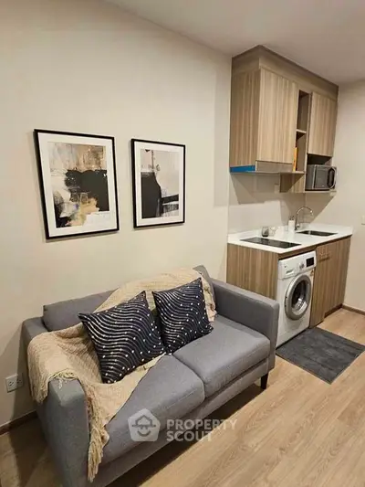 Modern compact living room with integrated kitchen and washing machine