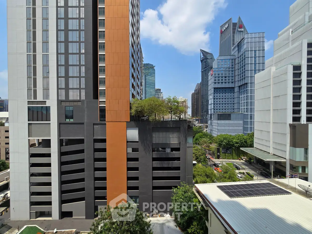 Stunning urban view showcasing modern high-rise buildings and vibrant cityscape under a clear blue sky.