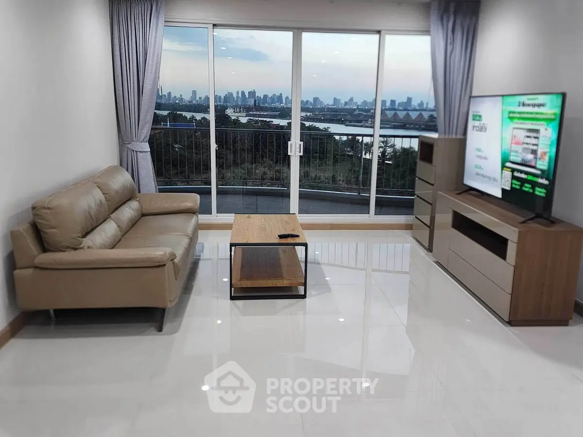 Spacious living room with stunning city view and modern furnishings
