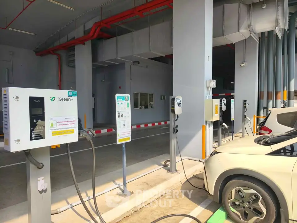 Modern electric vehicle charging station in a parking area with multiple charging points.