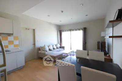 Modern open-layout living room with cozy sofa and dining area