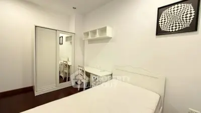 Minimalist bedroom with white furniture and modern art decor