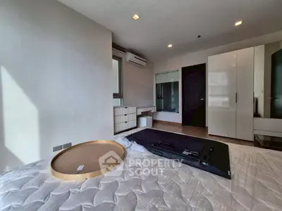Spacious bedroom with modern furniture and natural light
