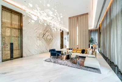 Luxurious modern living room with elegant decor and stunning lighting fixtures.