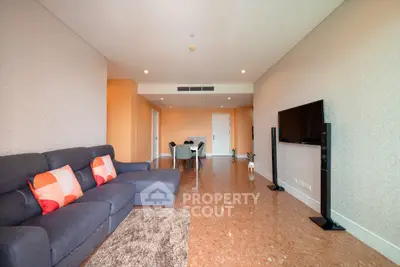 Spacious living room with modern decor and flat-screen TV, ideal for relaxation and entertainment.
