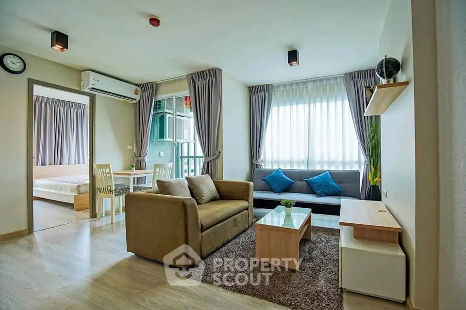 Spacious modern living room with cozy sofa and natural light in stylish apartment.