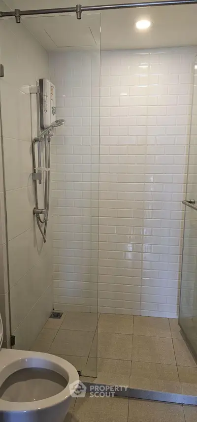 Modern bathroom with glass shower and white subway tiles