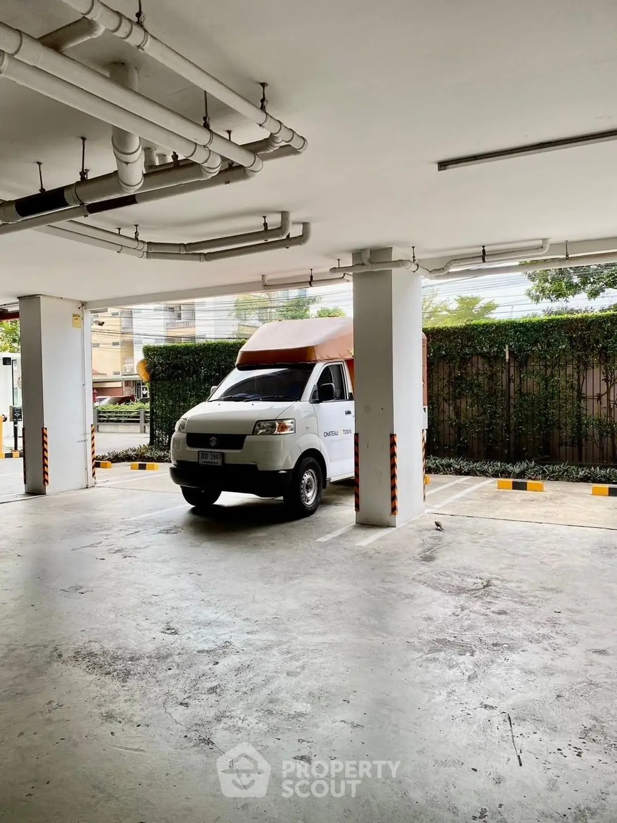 Spacious parking area with a delivery van in a modern residential complex.