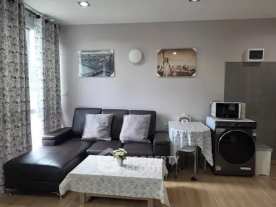 Modern living room with stylish sofa and washing machine in cozy apartment
