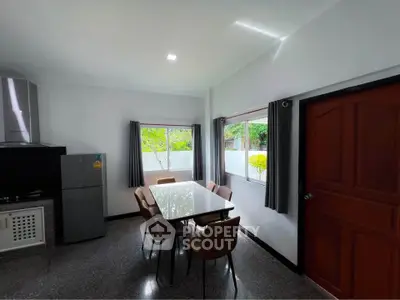 Modern kitchen with sleek dining area and large windows for natural light