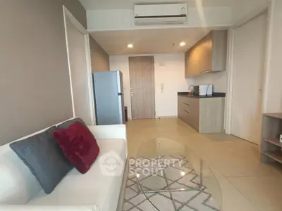 Modern living room with sleek kitchen, featuring stylish furniture and contemporary design.