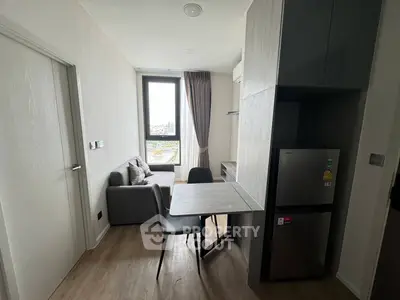 Modern compact living room with dining area and large window view