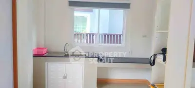 Bright kitchen area with modern cabinetry and window view