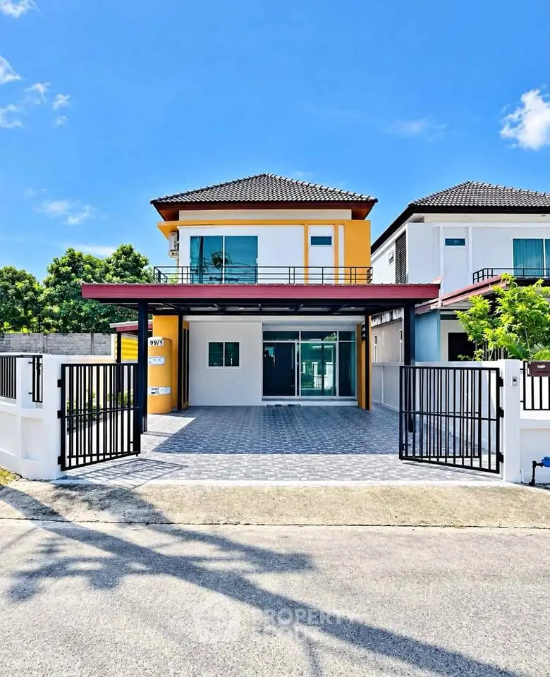 Modern two-story house with spacious driveway and stylish facade under clear blue sky.