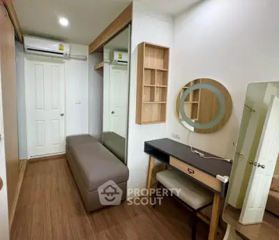 Modern bedroom with stylish vanity and ample storage space