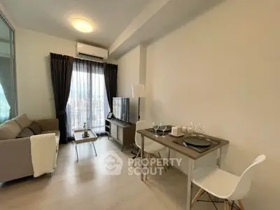Modern living room with cozy seating and dining area, featuring natural light and stylish decor.