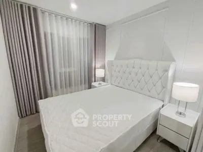 Elegant bedroom with plush white bed and modern nightstands in a serene setting.