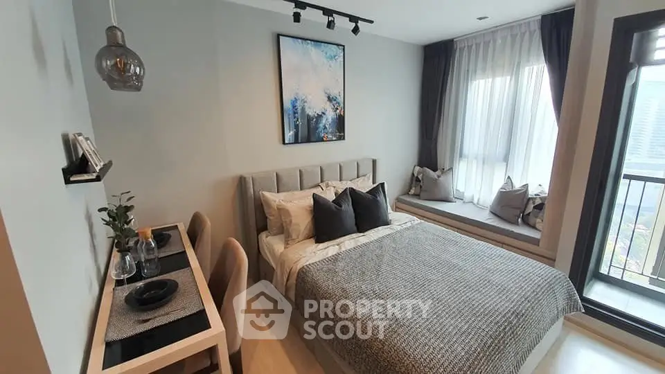 Modern bedroom with cozy decor and large window seating area