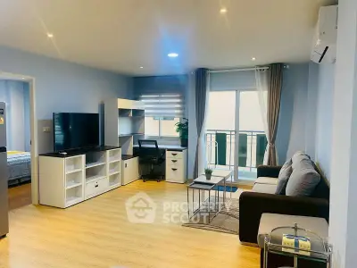 Modern living room with balcony access, featuring stylish furniture and ample natural light.