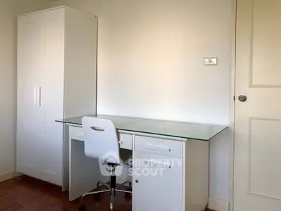 Modern study room with sleek desk and chair, ideal for productivity.