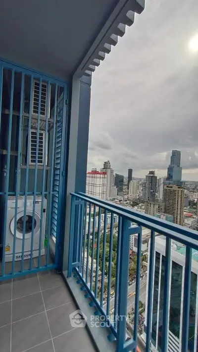 Stunning city view from high-rise balcony with laundry area, perfect for urban living.