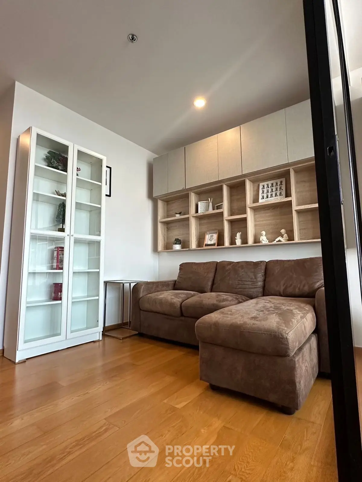 Modern living room with cozy sectional sofa and stylish shelving unit