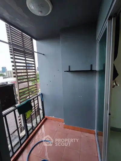 Cozy urban balcony with city view, perfect for relaxation and fresh air.