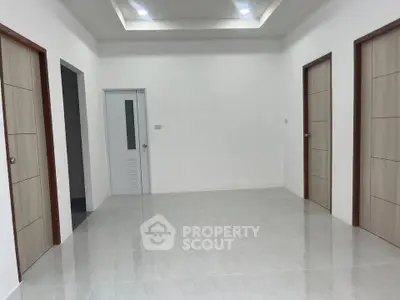 Spacious modern interior with multiple doors and sleek tile flooring