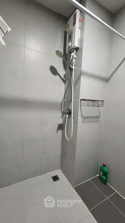 Modern bathroom with shower and tiled walls in a sleek design