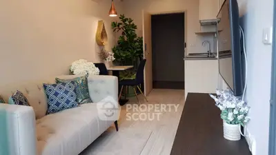Modern living room with stylish decor and open kitchen layout, perfect for urban living.