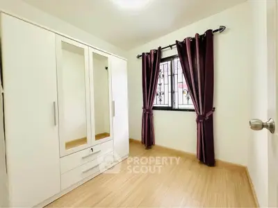 Spacious bedroom with elegant wardrobe and natural light