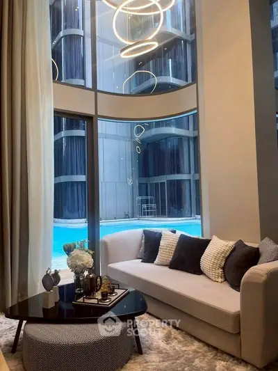 Luxurious living room with pool view and modern decor