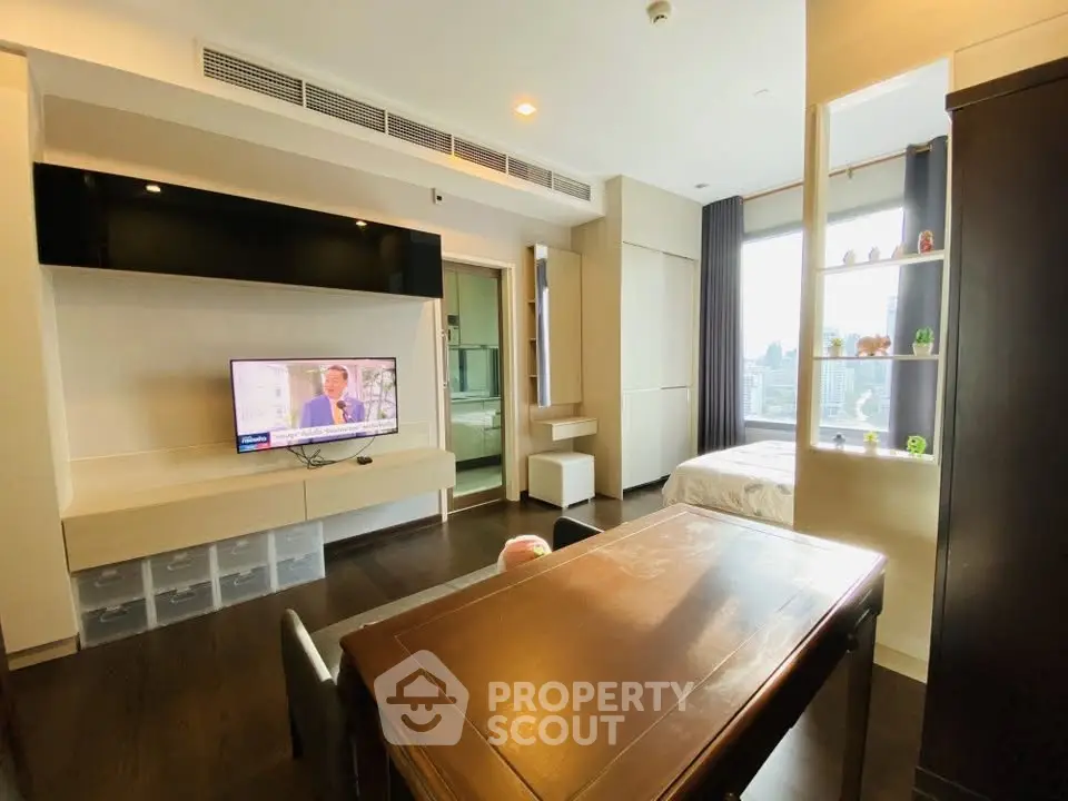 Modern studio apartment with open layout, featuring a cozy living area and bedroom with city views.
