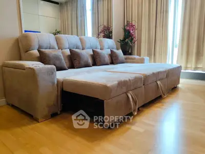 Spacious living room with plush sectional sofa and natural light