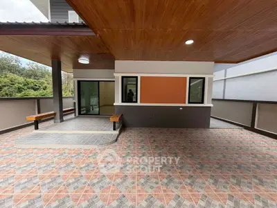Spacious outdoor patio with modern design and tiled flooring, perfect for relaxation and entertainment.