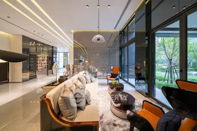 Luxurious modern living room with elegant decor and large windows overlooking a lush garden.