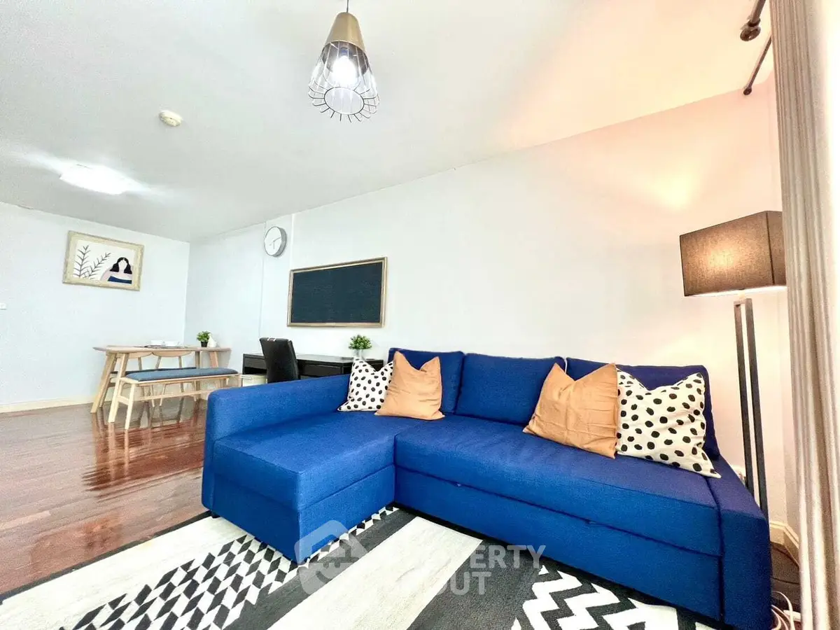 Spacious living room with modern blue sofa and stylish decor