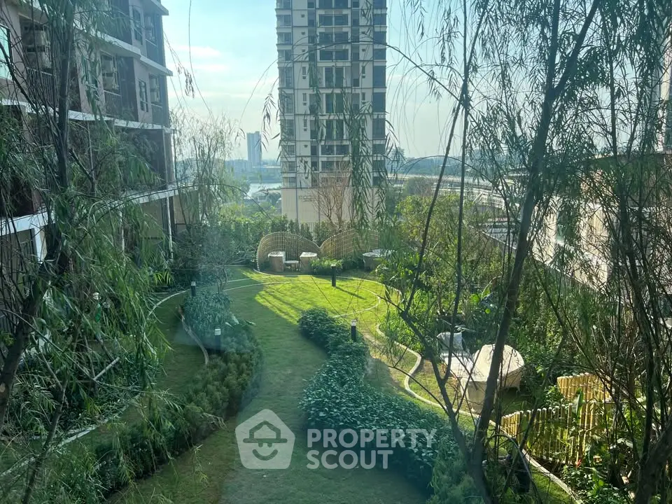 Lush garden view from a modern residential building, showcasing serene green space and urban skyline.