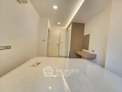 Modern minimalist bedroom with sleek design and built-in storage
