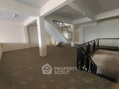 Spacious interior with modern staircase and open layout, ideal for customization.