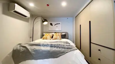 Modern bedroom with stylish decor and ample storage space